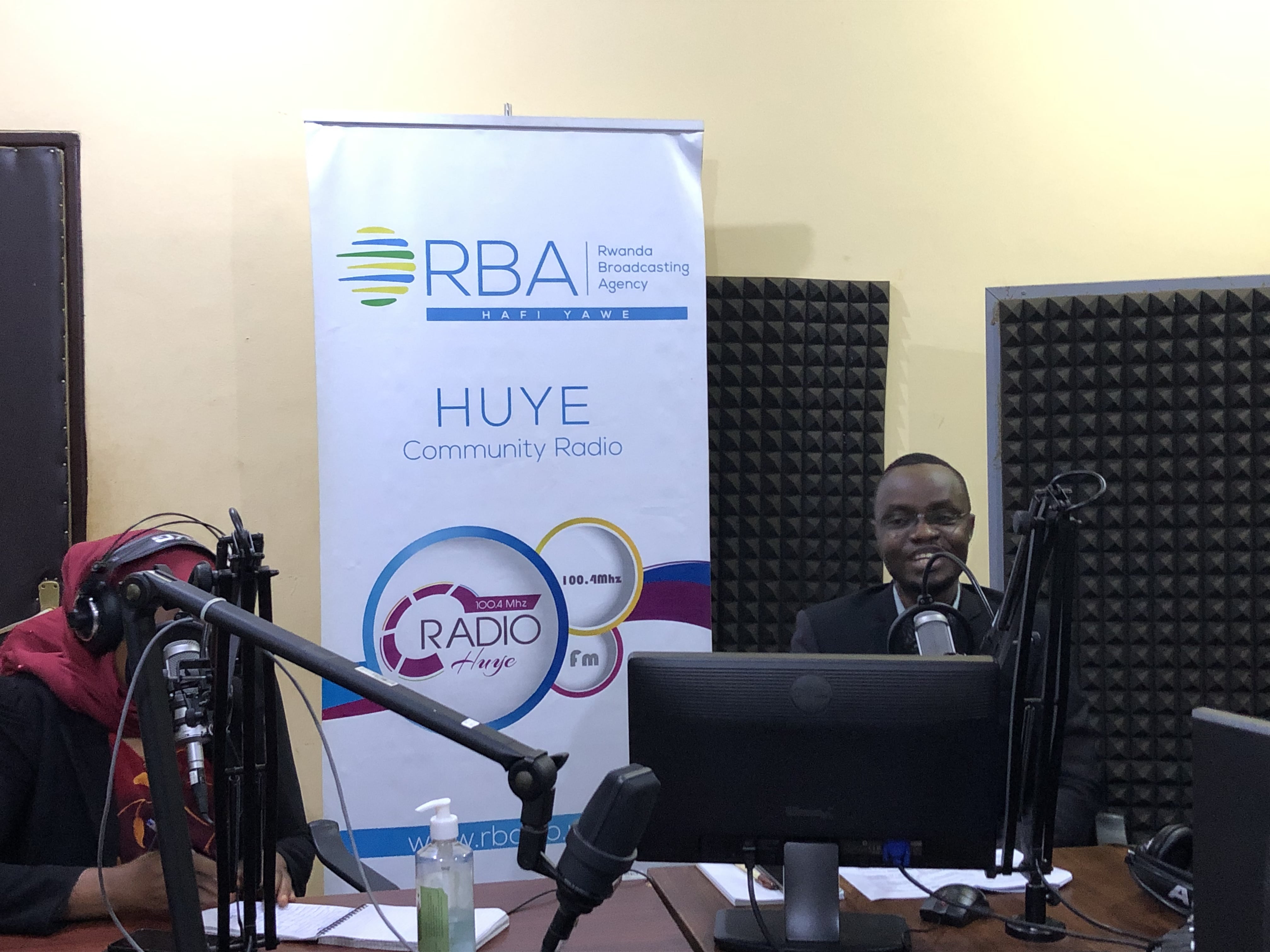 The radio host in studio with technical equipment and a mice in front of him.